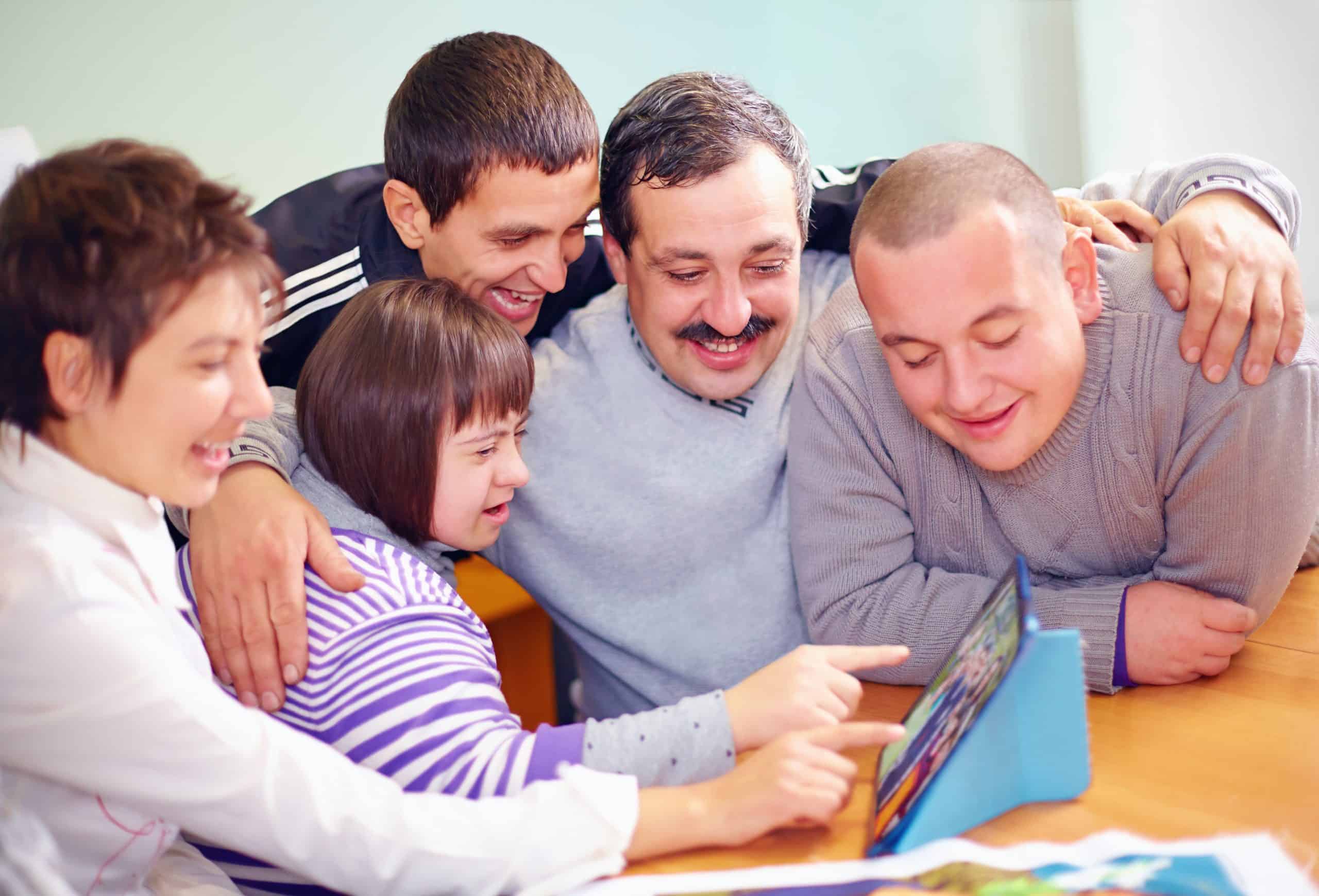 People looking at tablet screen
